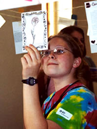 Student reading another student's poetry.