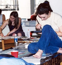 Two students preparing art work for exhibition.